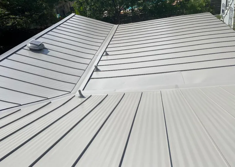 Solar attic fan installed on a metal roof for Roof Ventilation in Sugar Land